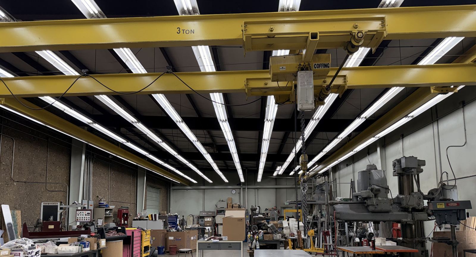 The tool room under its yellow 3-ton bridge crane, with mills and benches below
